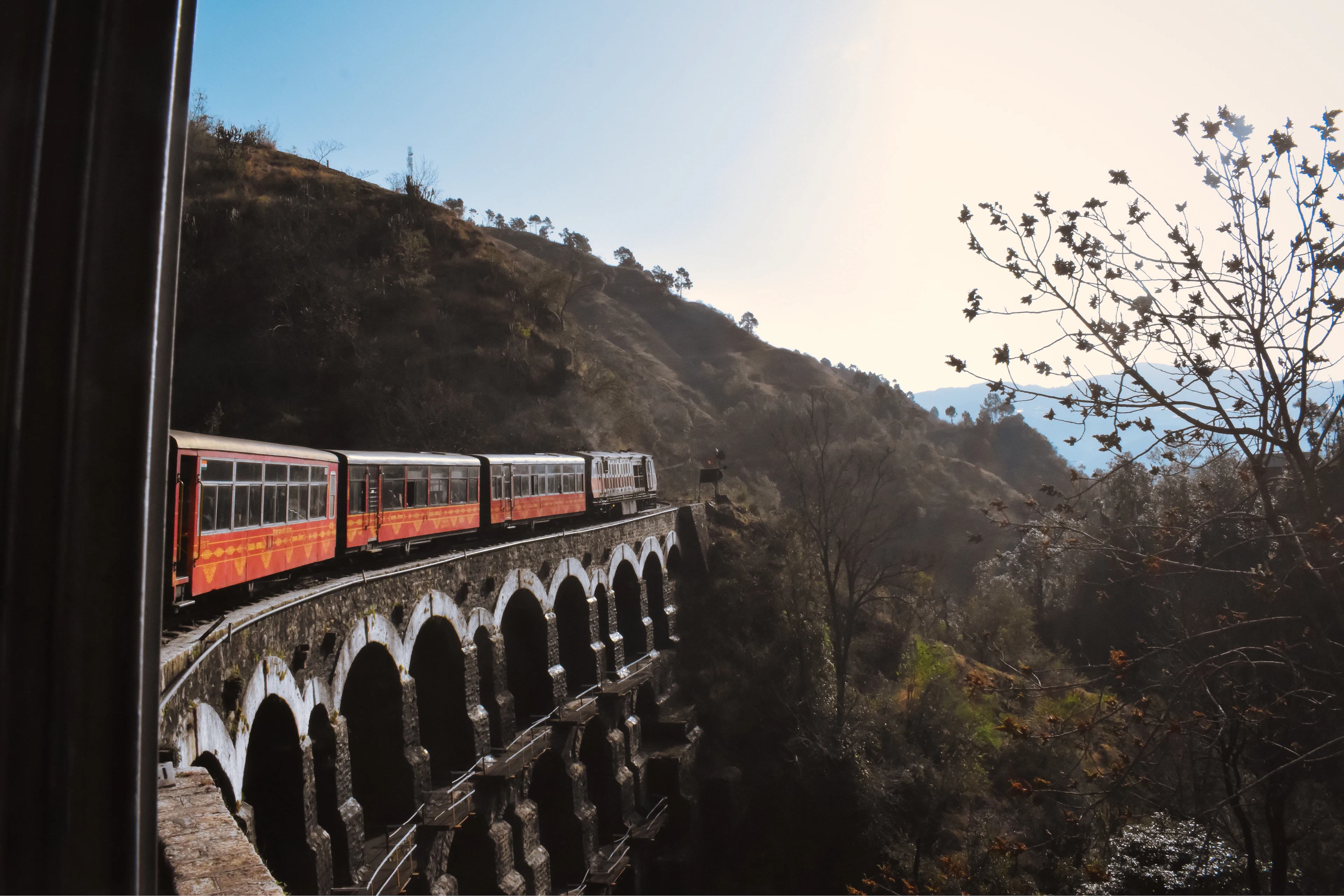 A train crossing a bridge in the mountains