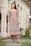 A joyful woman wearing an elegant kurti from narivastra, standing in a sunlit garden.