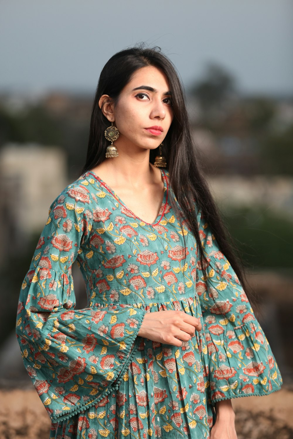 a woman with long hair wearing a dress