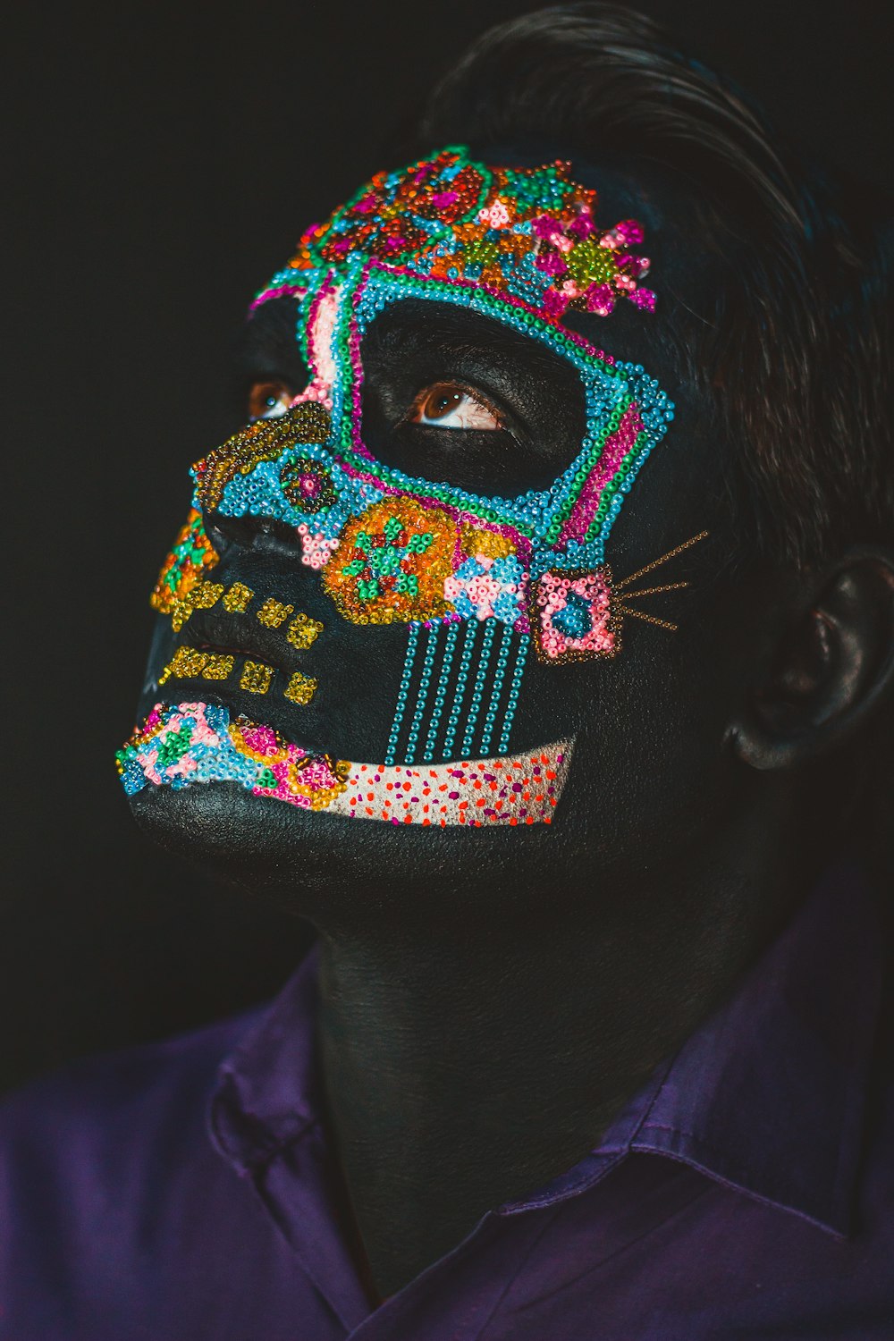 a man with a painted skull on his face