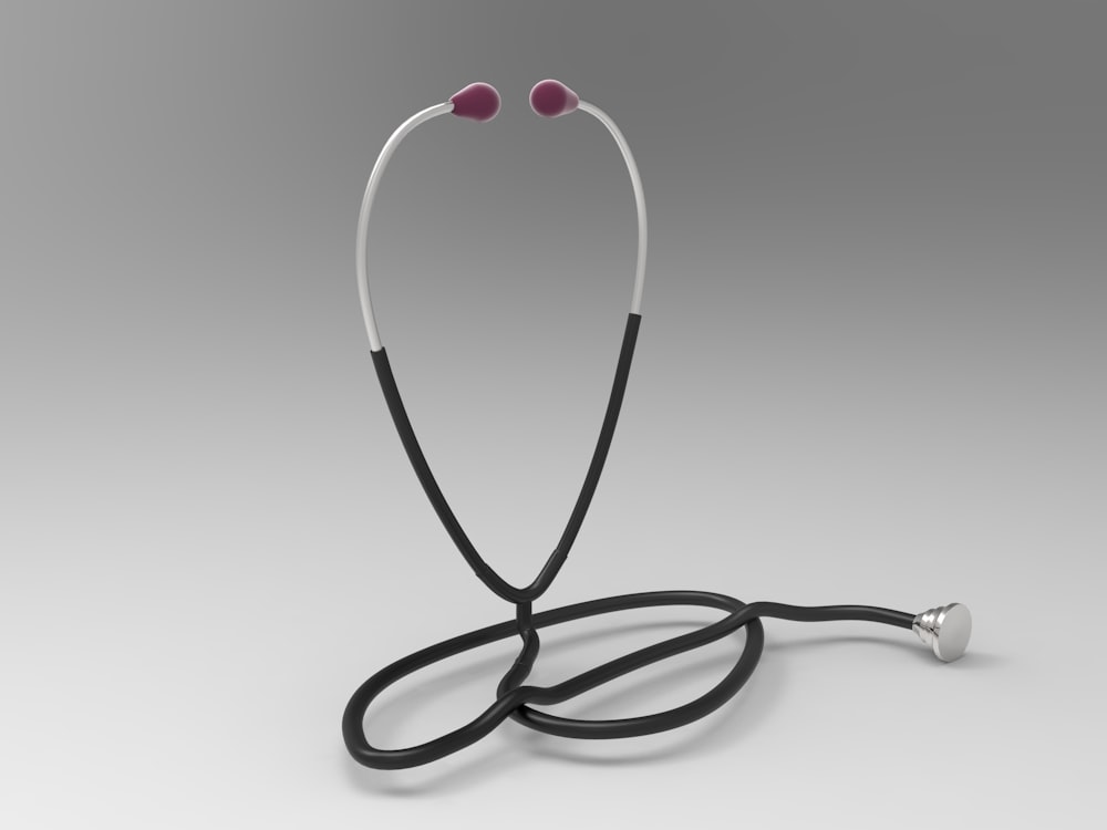 a pair of ear buds sitting on top of a black cord