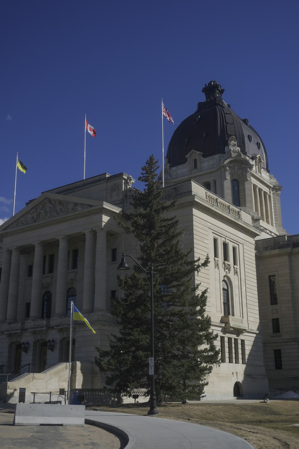 a large building with a dome and flags on top of it