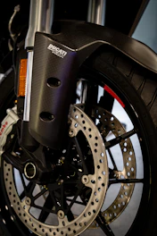 Close-up of carbon fiber pit bike parts branded for YCF and Apollo.