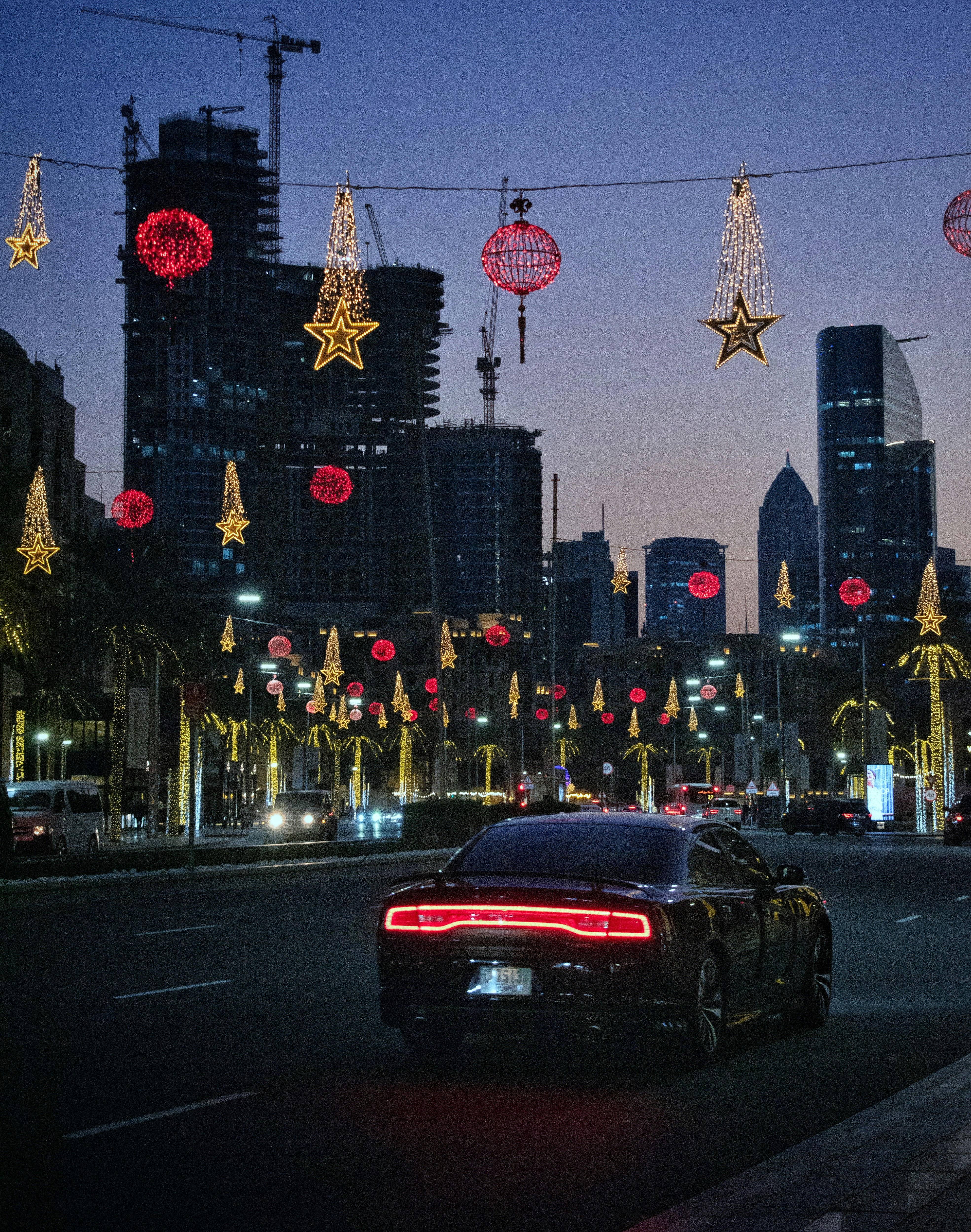 A car driving down a city street at night photo – Free Car Image on ...