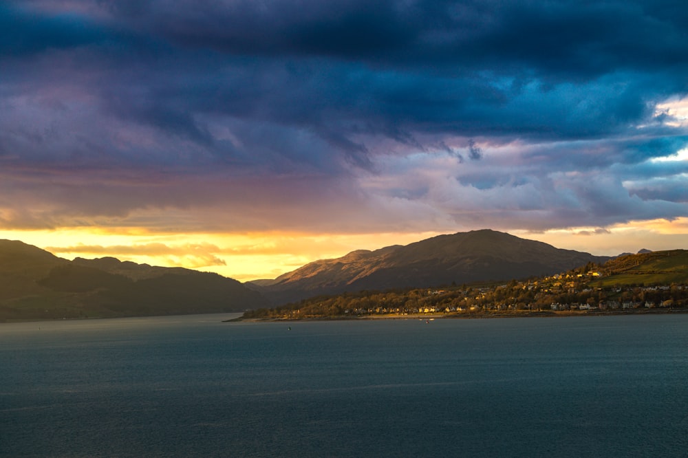 a large body of water under a cloudy sky