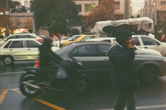 a person on a cell phone on a busy street