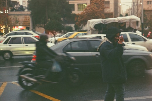 a person on a cell phone on a busy street