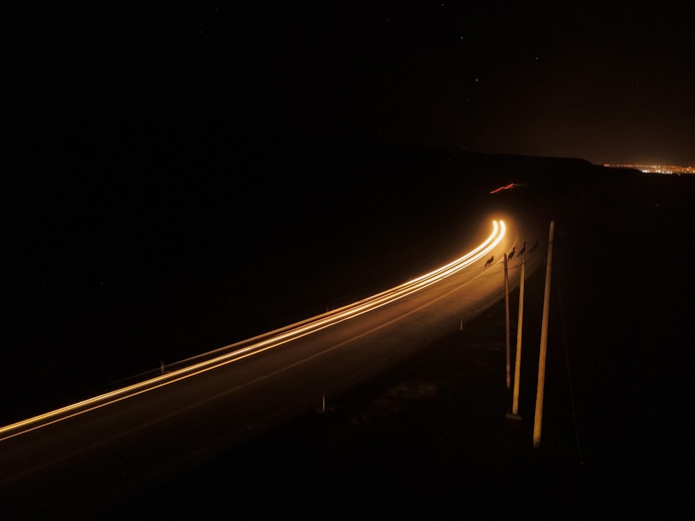 a long exposure photo of a highway at night