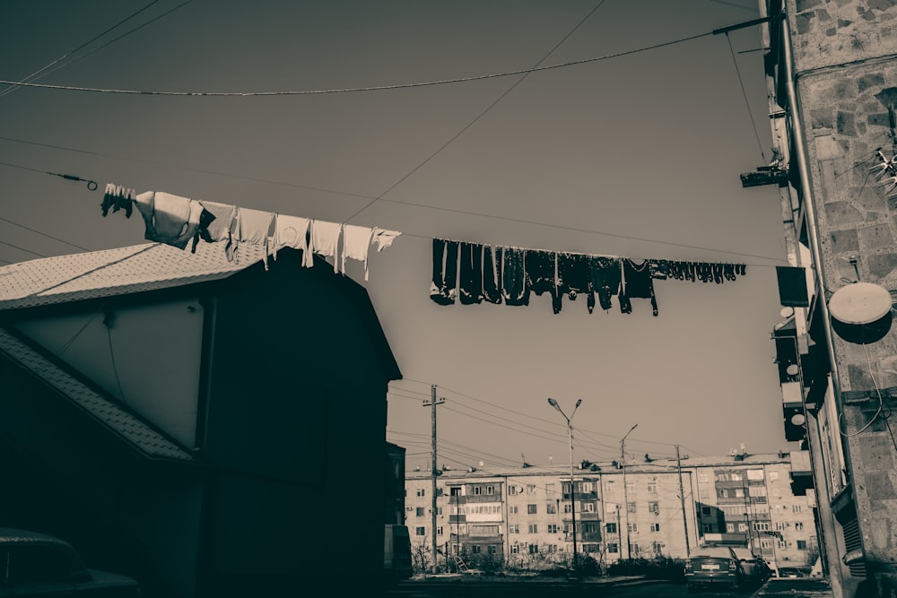 a black and white photo of clothes hanging on a line