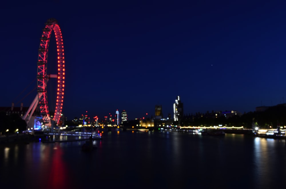 a ferris wheel lit up in the night sky