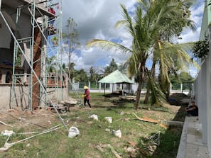 A construction site with scaffolding and workers preparing the foundation.