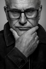 a black and white photo of a man with glasses
