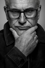 a black and white photo of a man with glasses