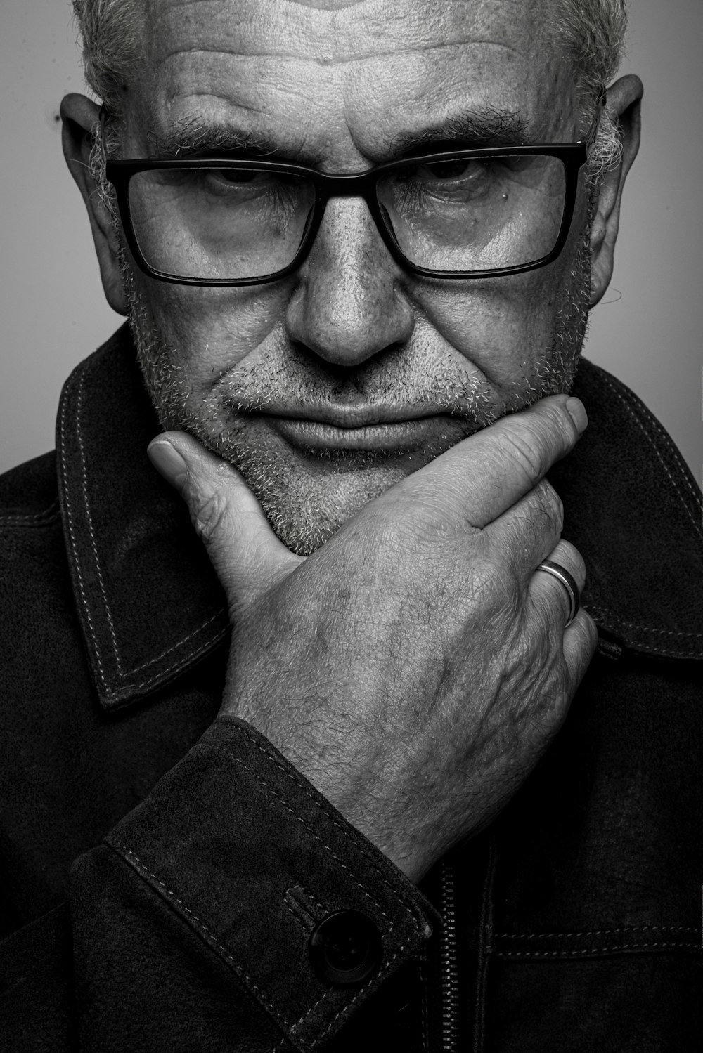 a black and white photo of a man with glasses