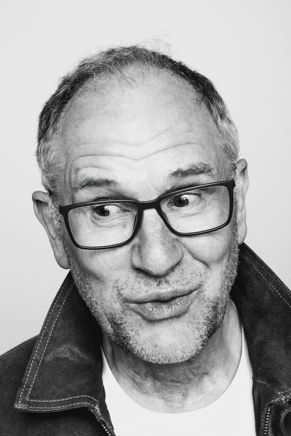 a black and white photo of a man with glasses