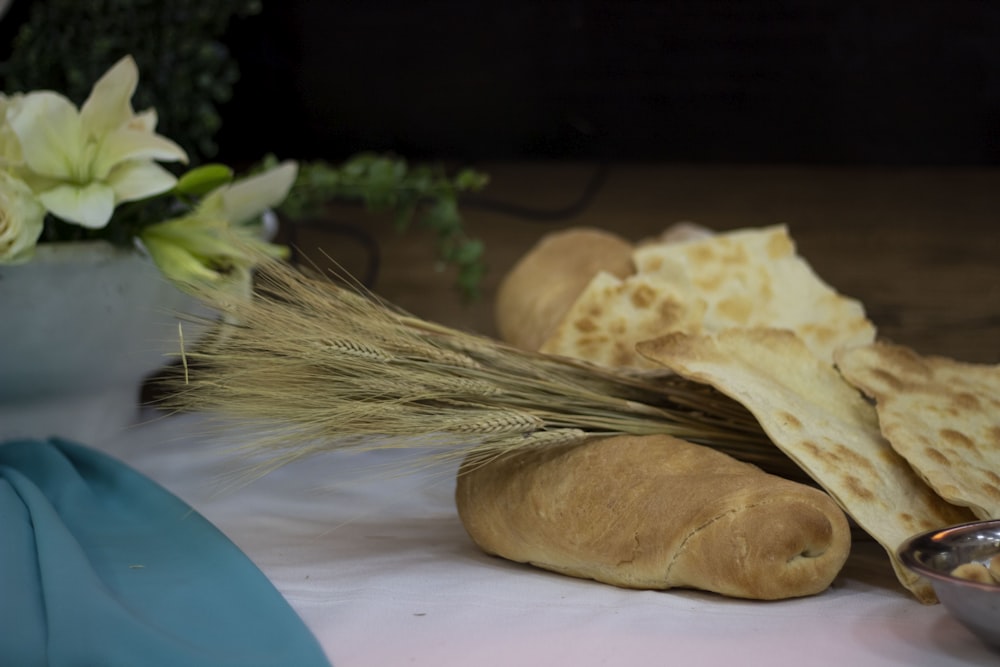 a table topped with bread and a bowl of dip