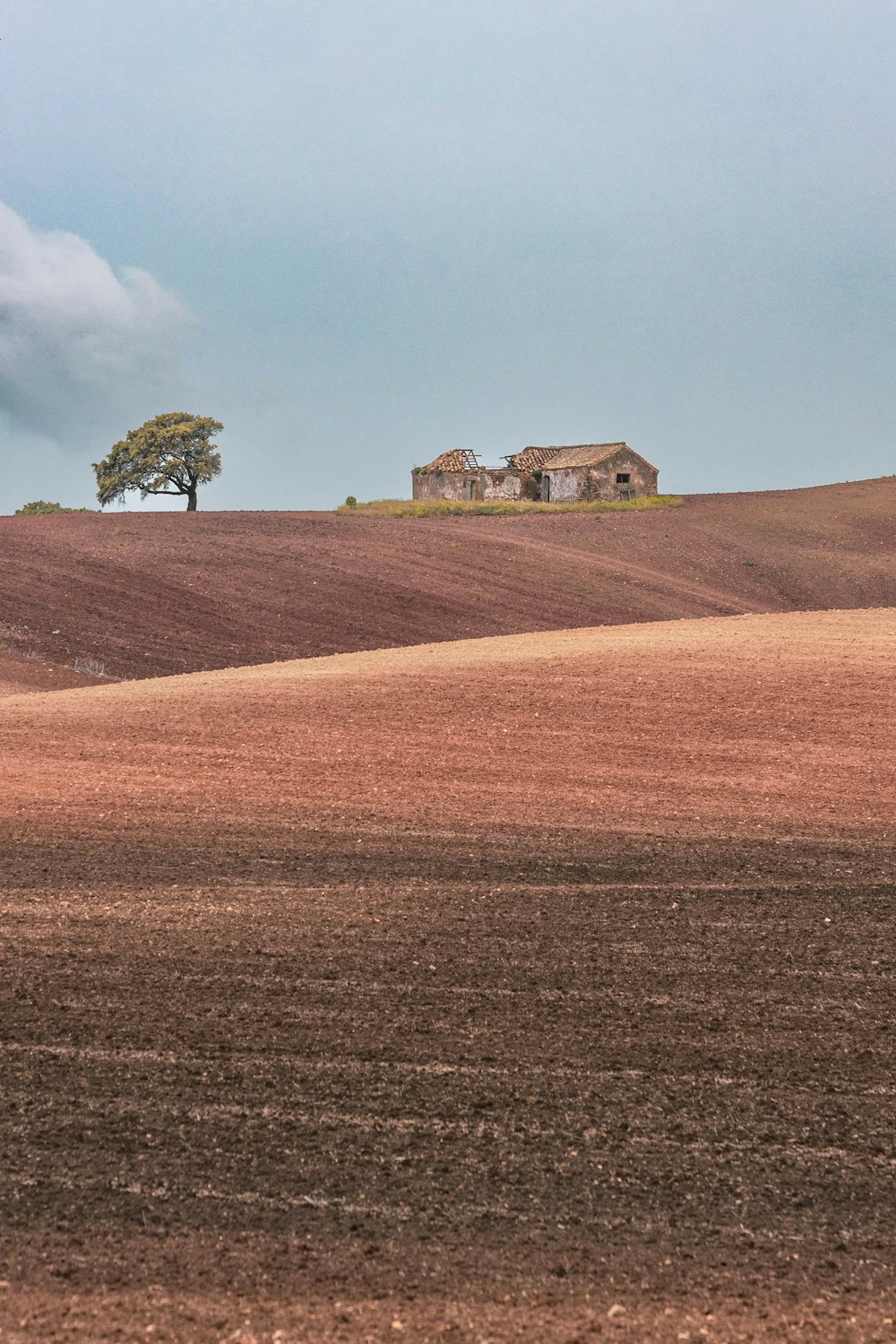 a large field with a house on top of it