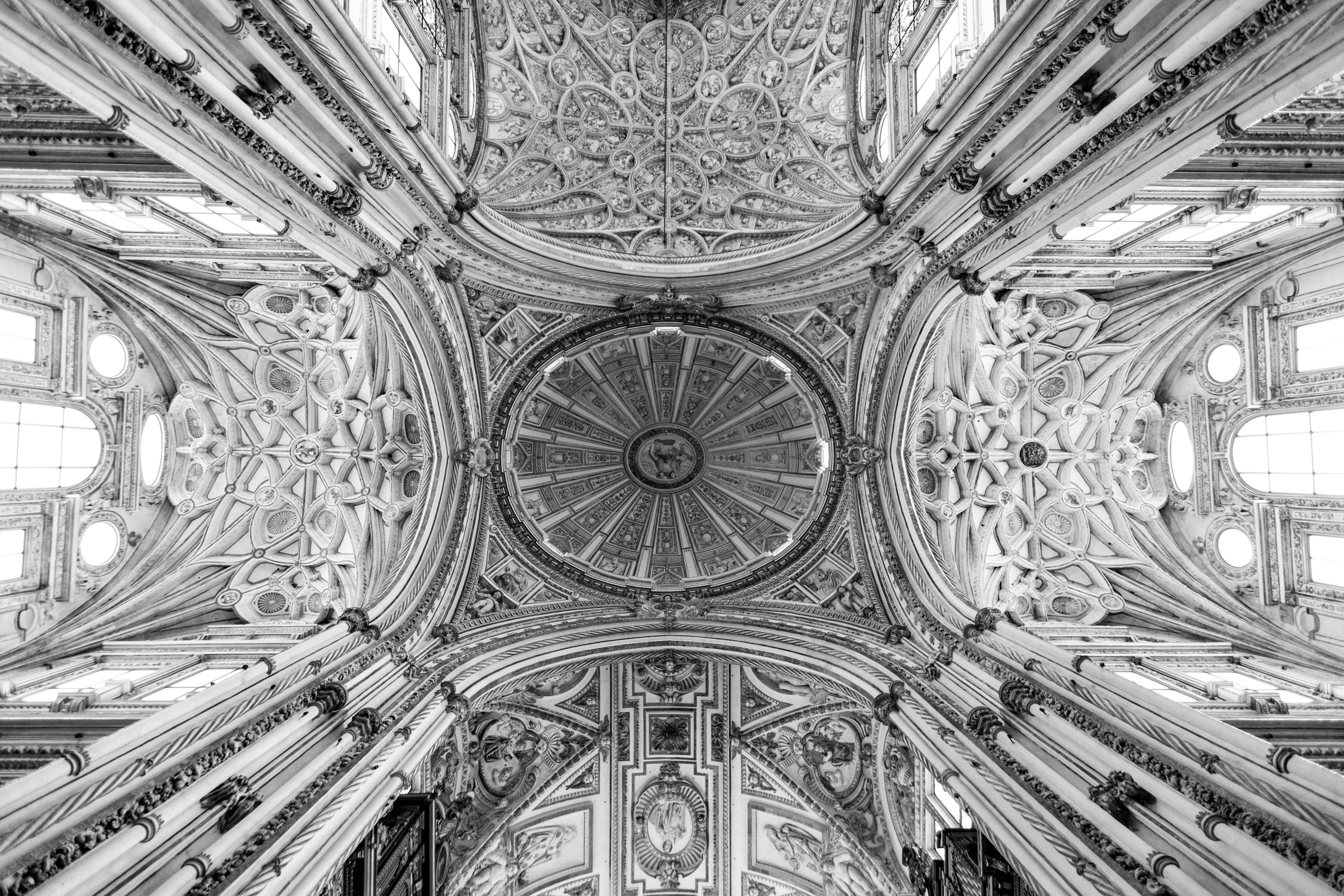 a black and white photo of the ceiling of a church