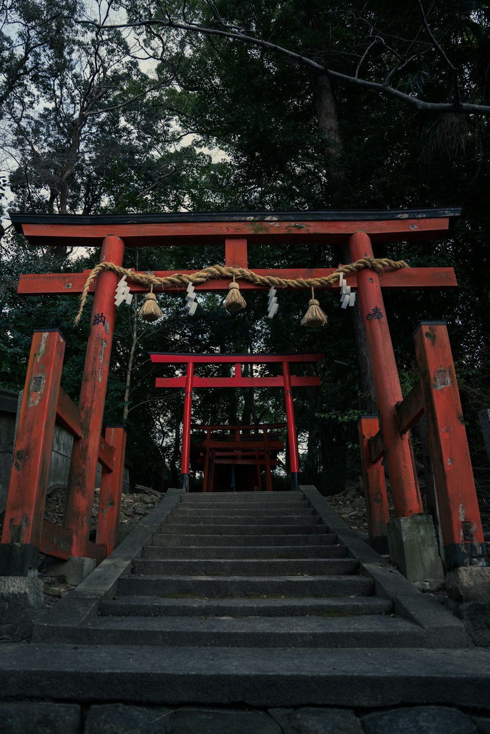 a red gate with steps leading up to it