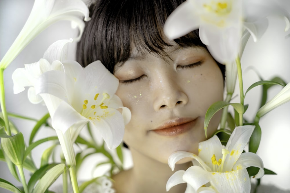 a woman with her eyes closed and flowers in her hair