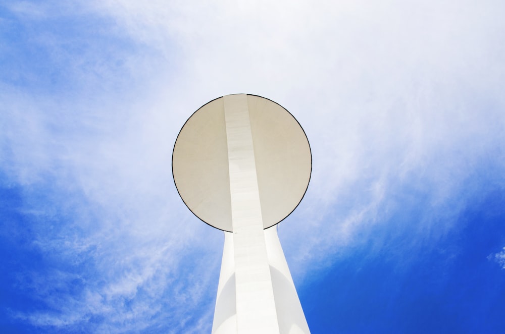 a tall white tower with a blue sky in the background