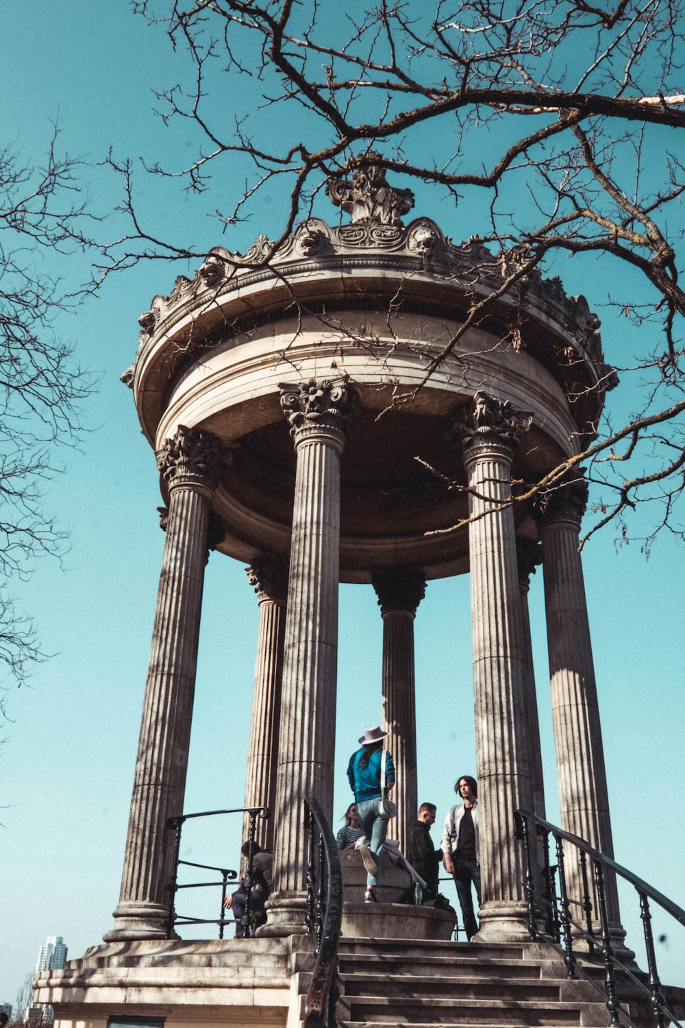 a group of people standing on top of a stone structure