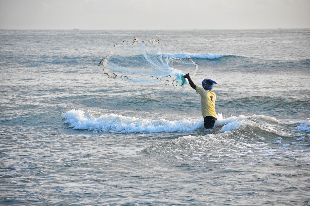 a person in the water with a kite