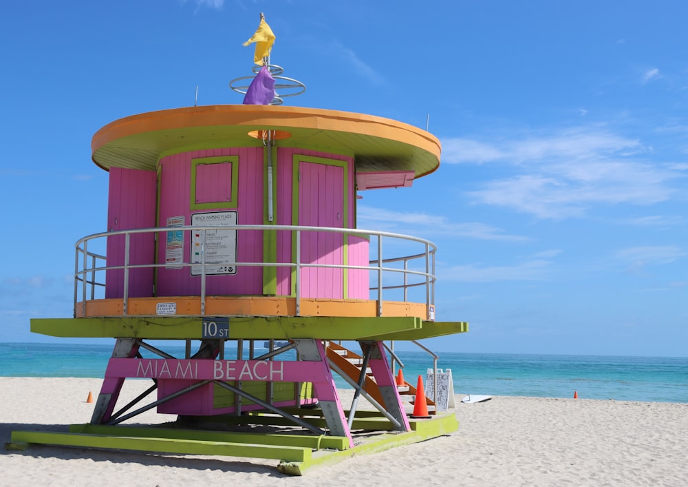 a lifeguard tower on the beach with a life guard on top