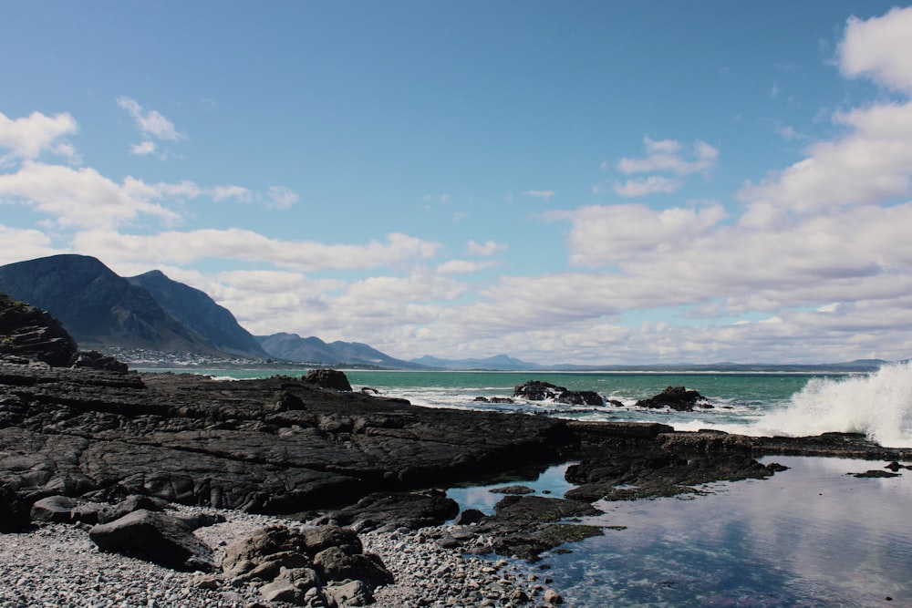 a body of water surrounded by rocks and mountains