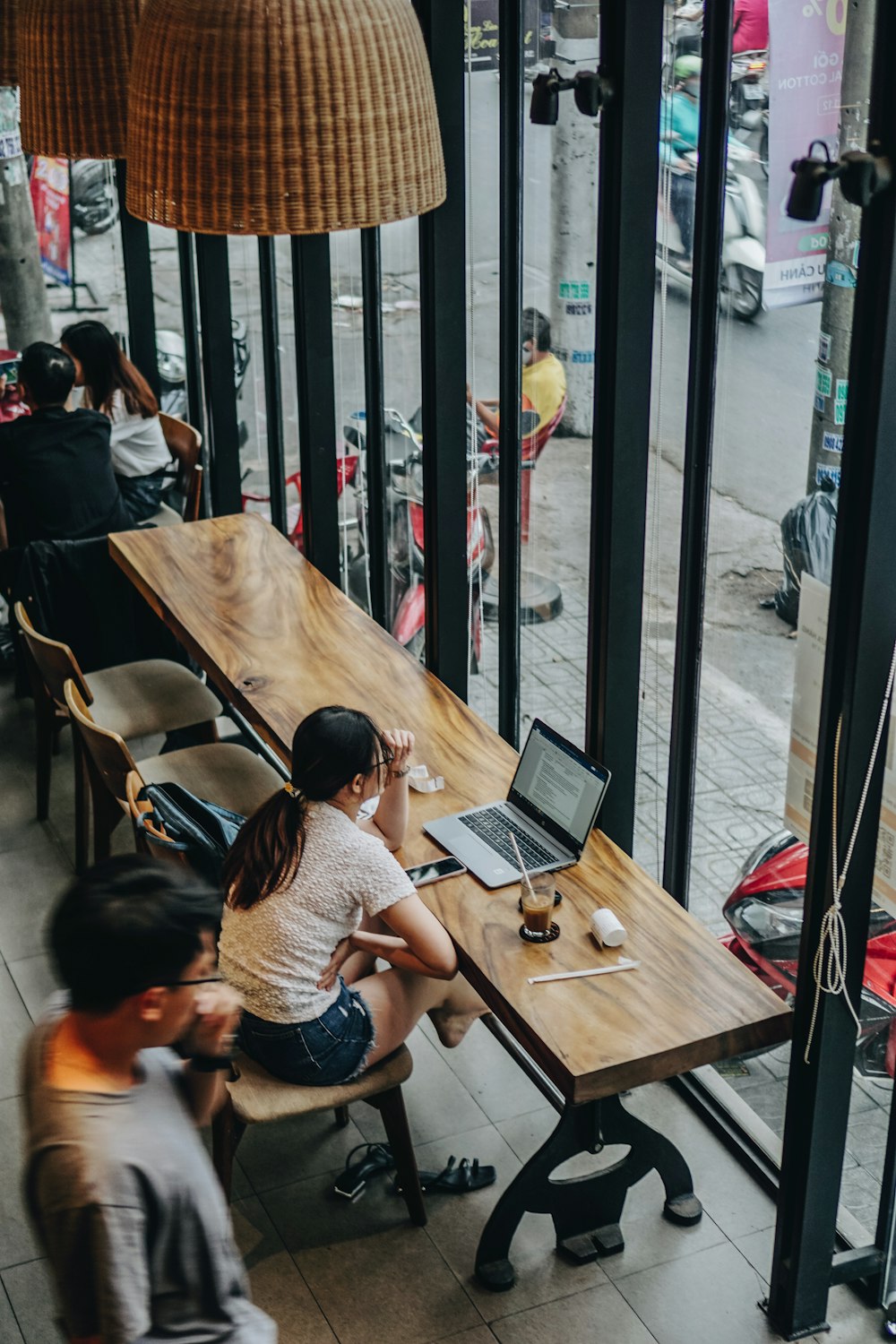 a couple of people sitting at a table with laptops