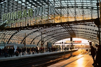 A friendly driver greeting a passenger at a busy Berlin train station.