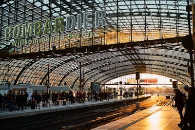 A friendly driver greeting a passenger at a busy Berlin train station.