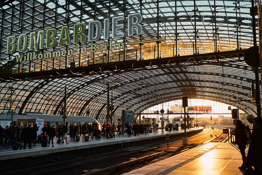 a train station with people waiting for the train