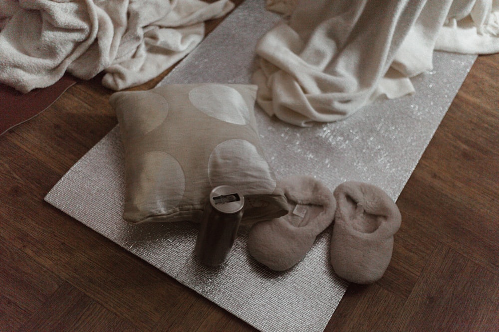 a pair of slippers sitting on top of a yoga mat