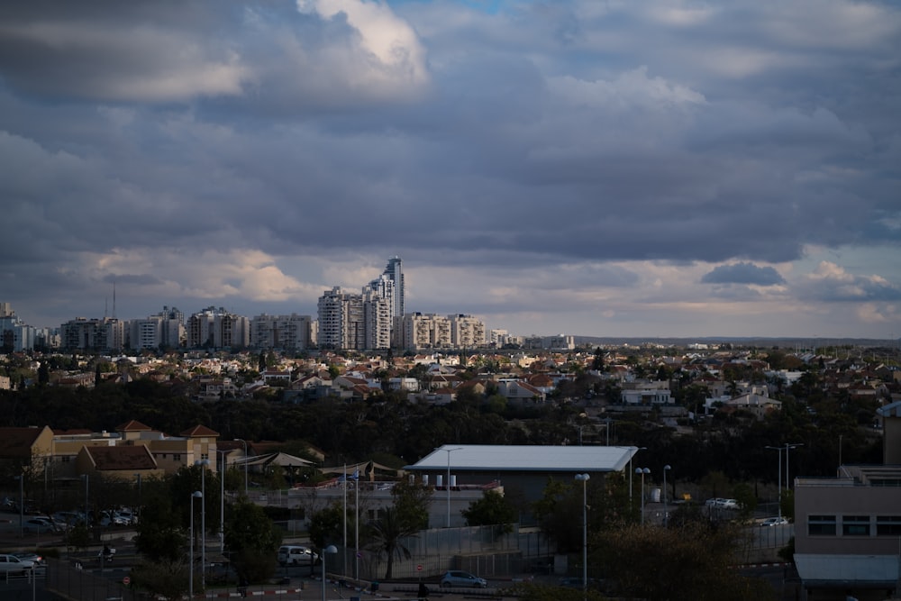 a view of a city with tall buildings under a cloudy sky
