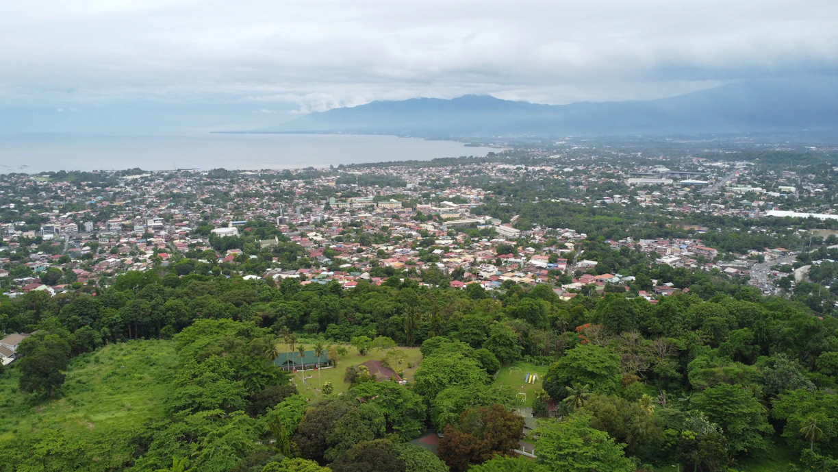 an aerial view of a city with a lake in the background