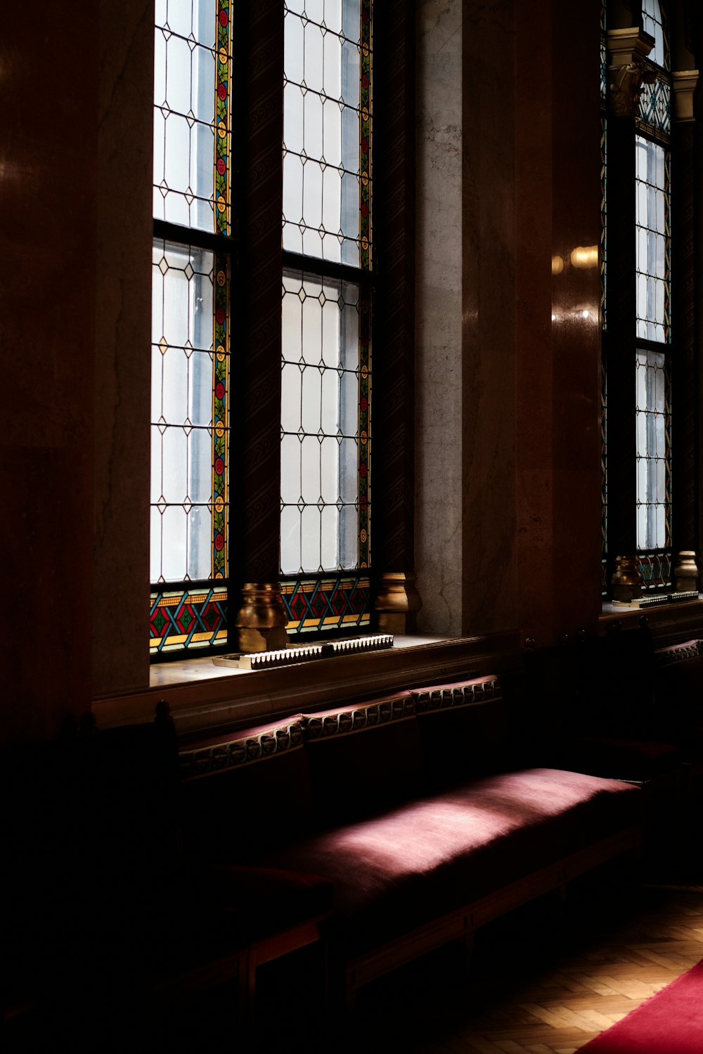 a church with stained glass windows and a red carpet