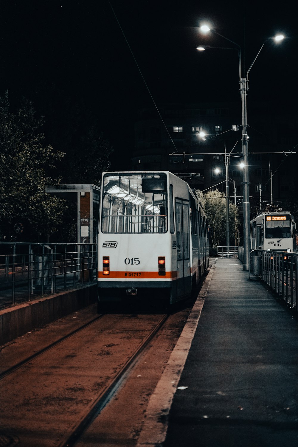 a white and orange train at a train station