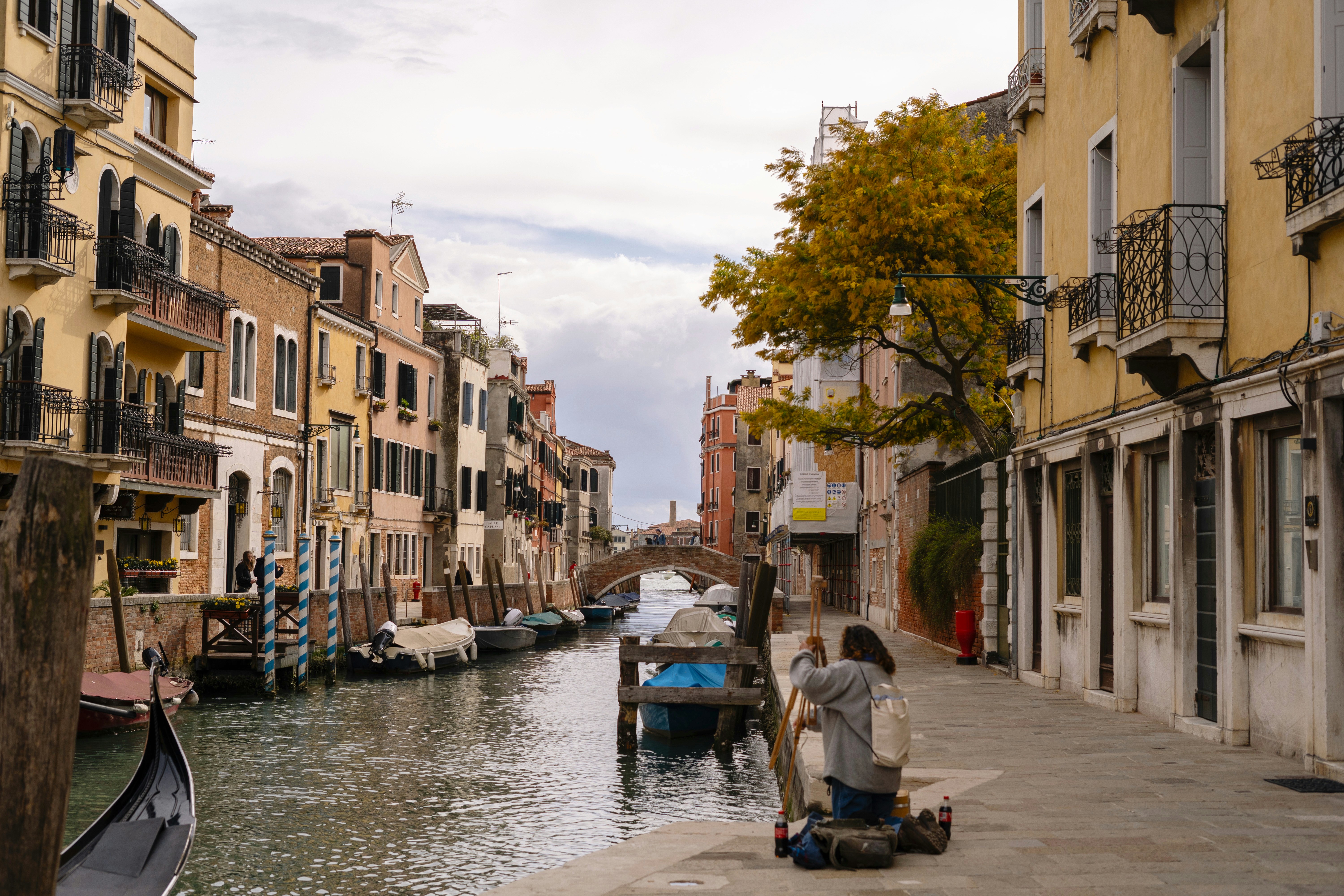 a couple of people sitting on a bench next to a body of water