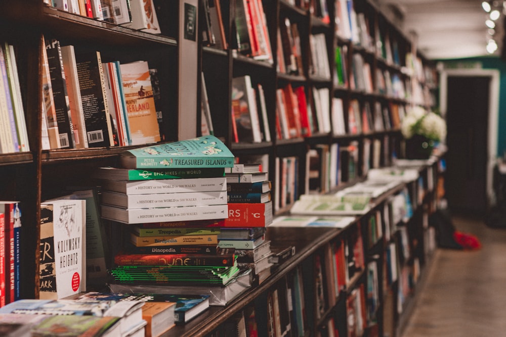 a bookshelf filled with lots of books in a library