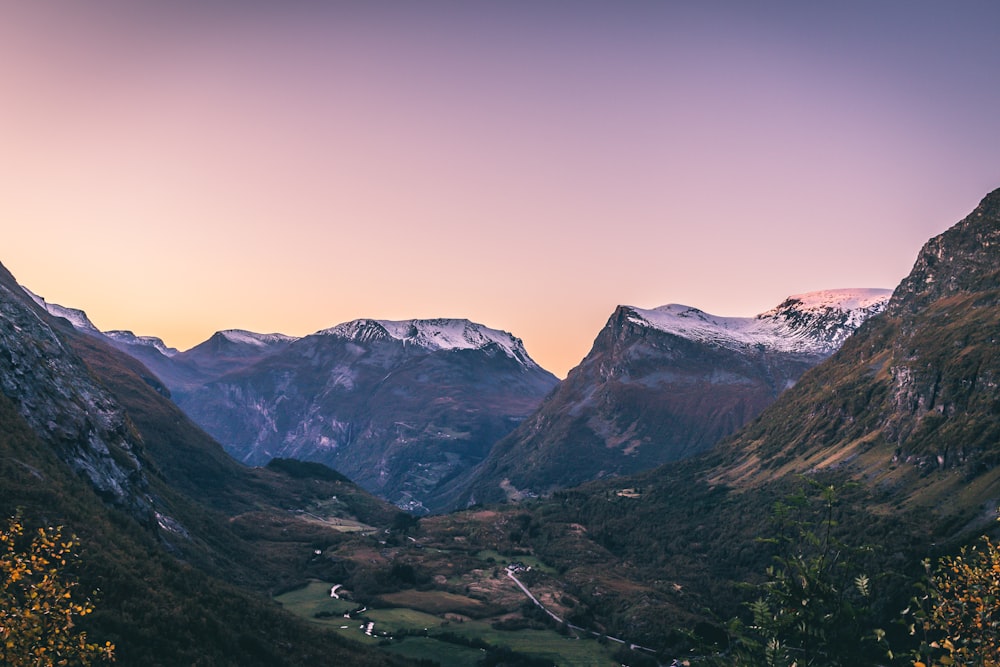 a view of a valley with mountains in the background