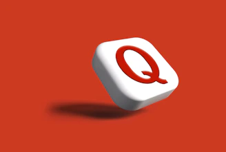 a white object with a red q on it