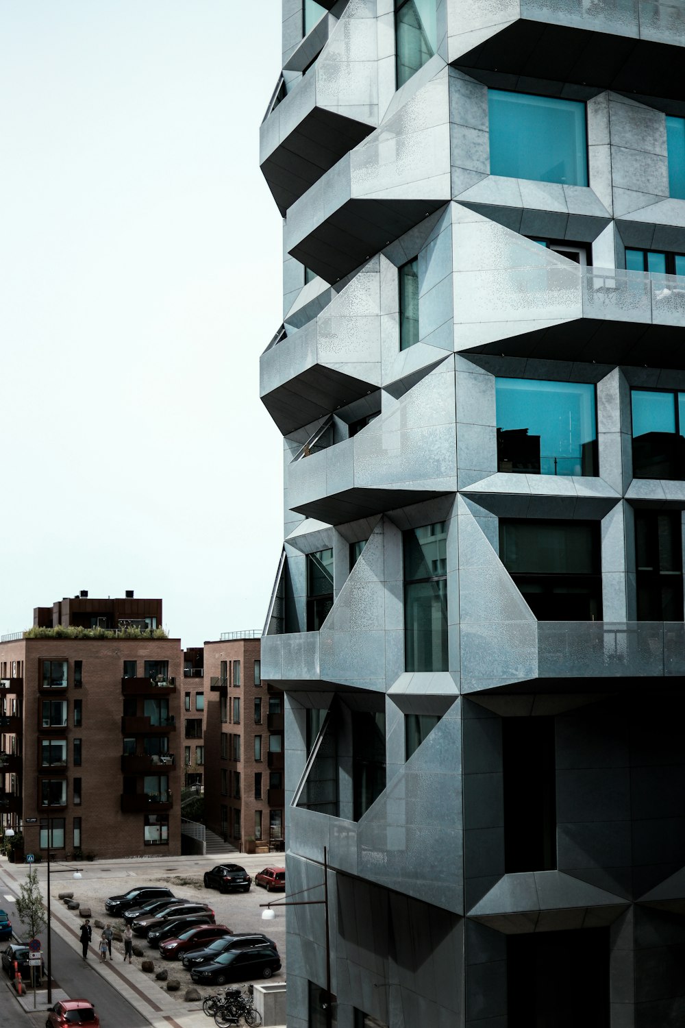 a tall building with many windows next to a street