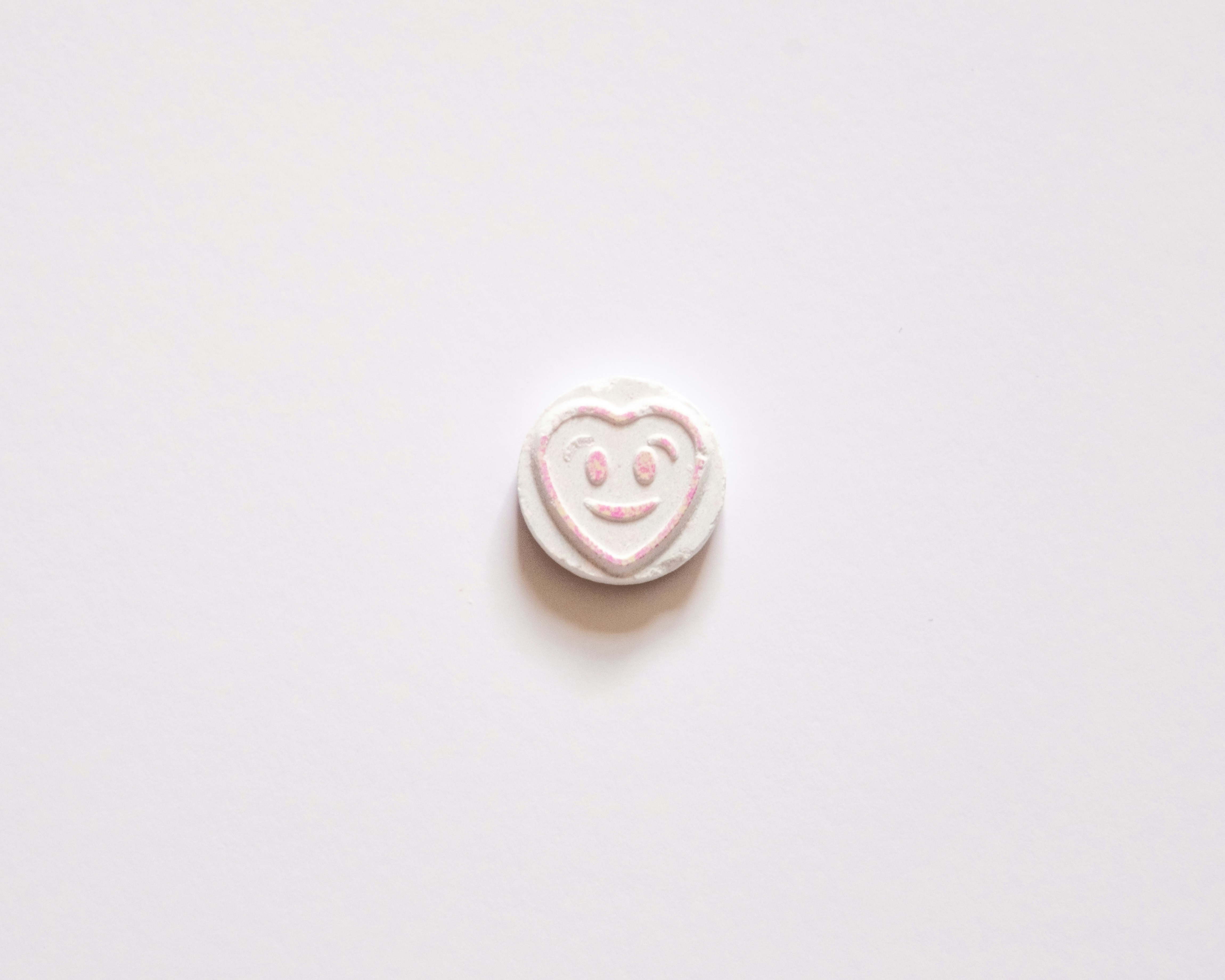 a white button with a smiley face on it