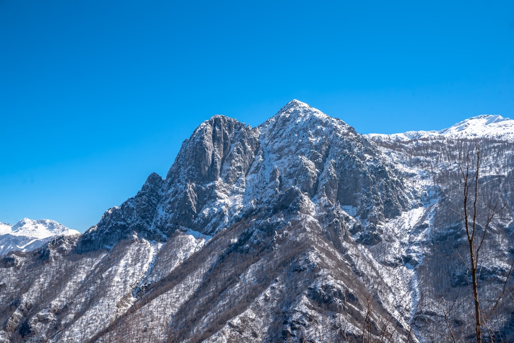 a snow covered mountain with a clear blue sky