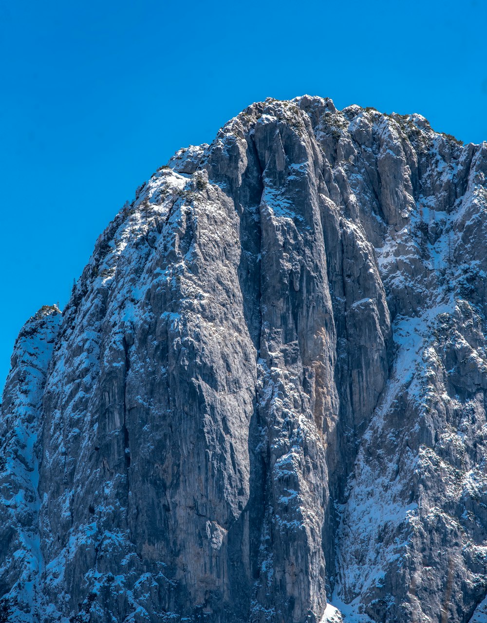 a snow covered mountain with a clear blue sky