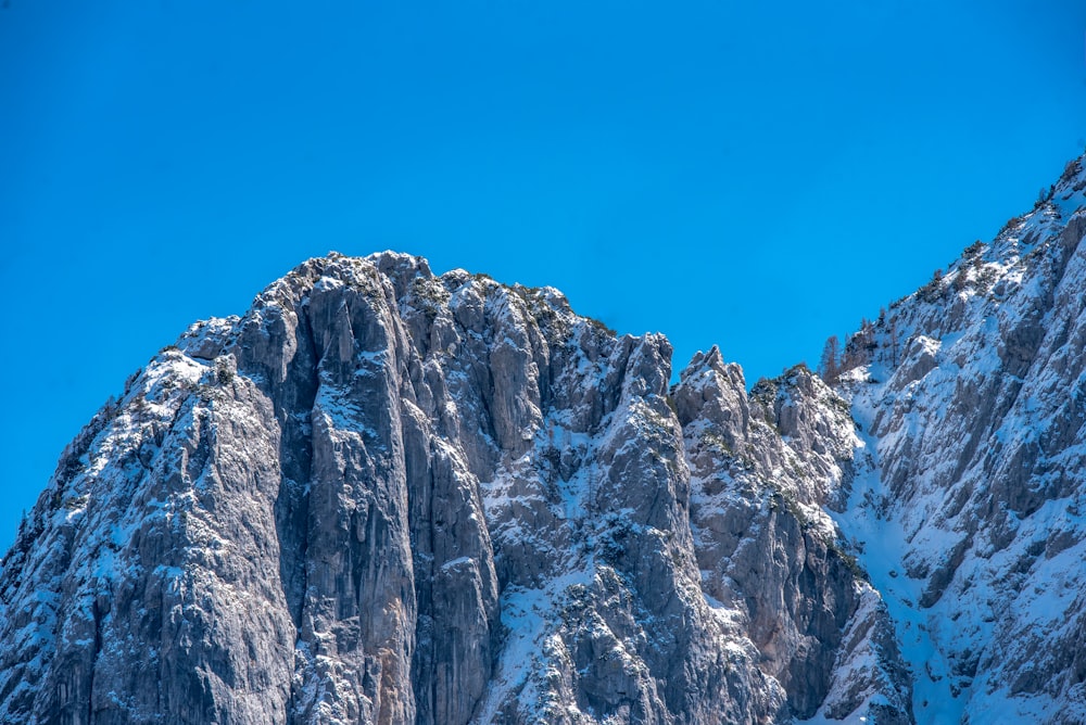 uma montanha coberta de neve com um céu azul claro