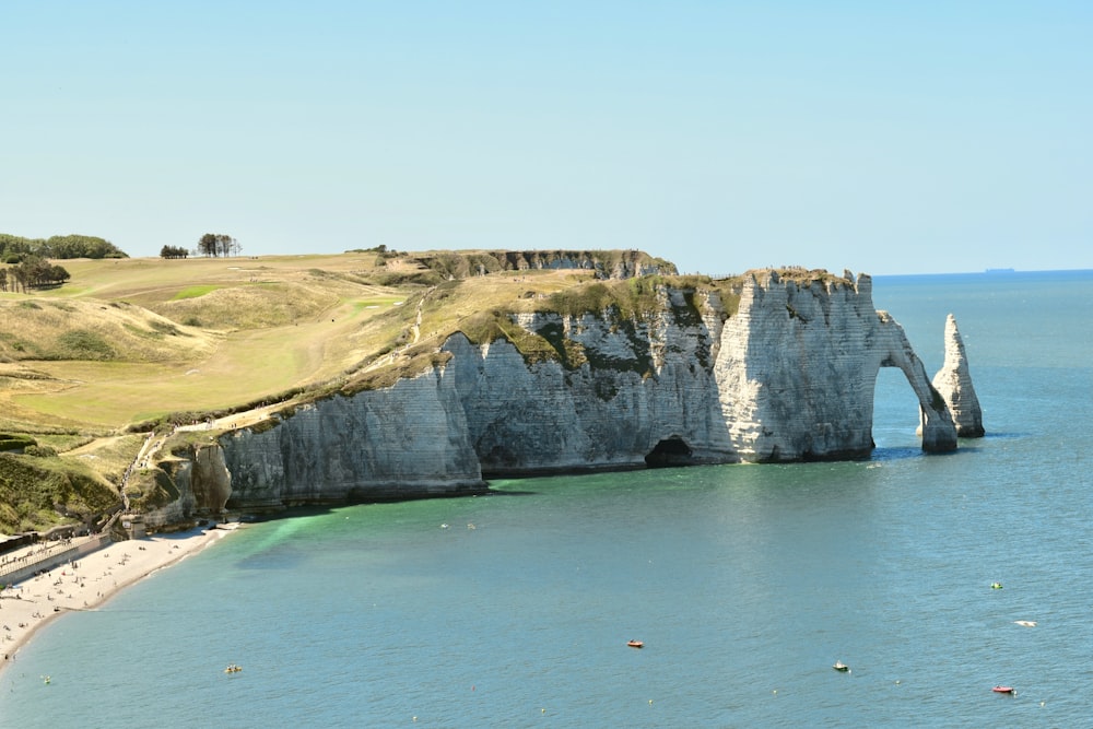 a large body of water next to a cliff