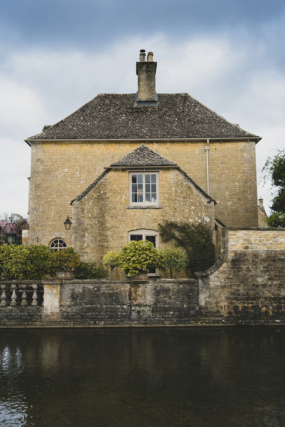 a large building with a clock tower next to a body of water