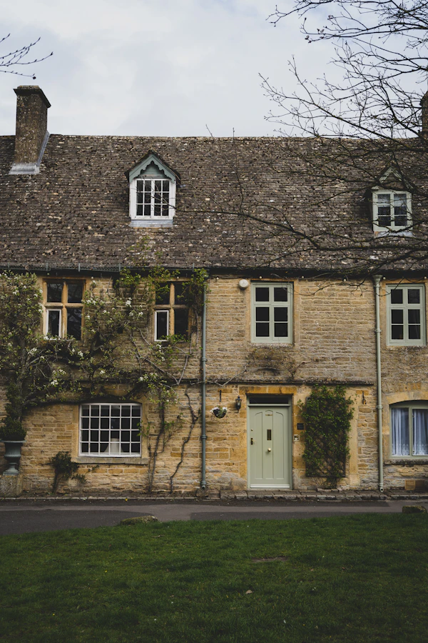 A Cotswold stone home with a green front door